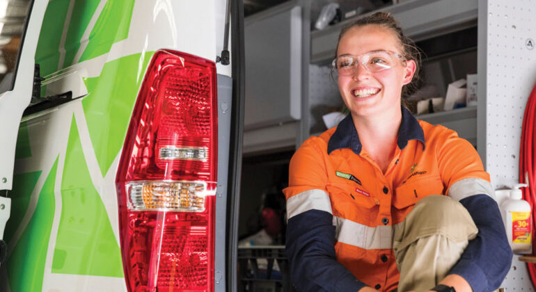 Team member sitting in the back of a work van