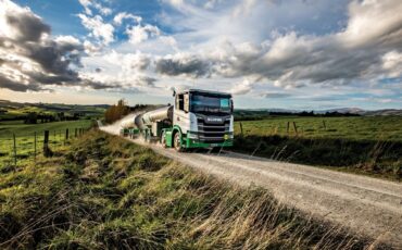 Milk tanker driving on a rural road