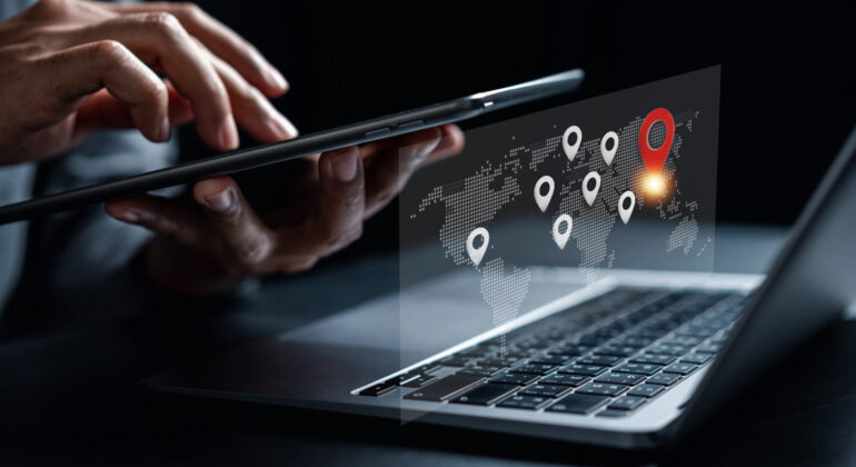 Businessman using smartphone synchronize computer searching world map with location point, GPS app, Destination travel maps and find places in the online system, searching by satellite system.